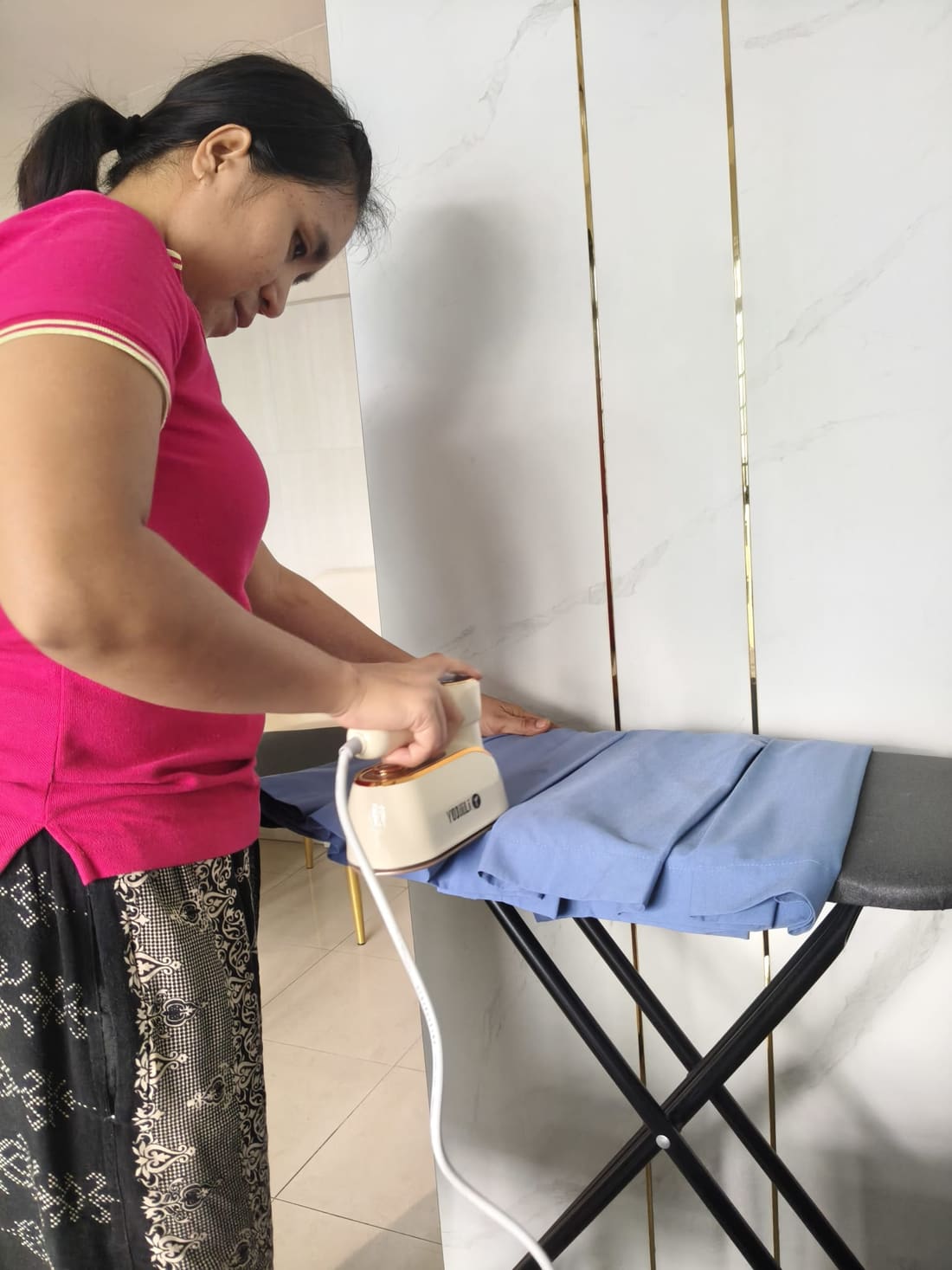 Helper ironing in a Singapore home
