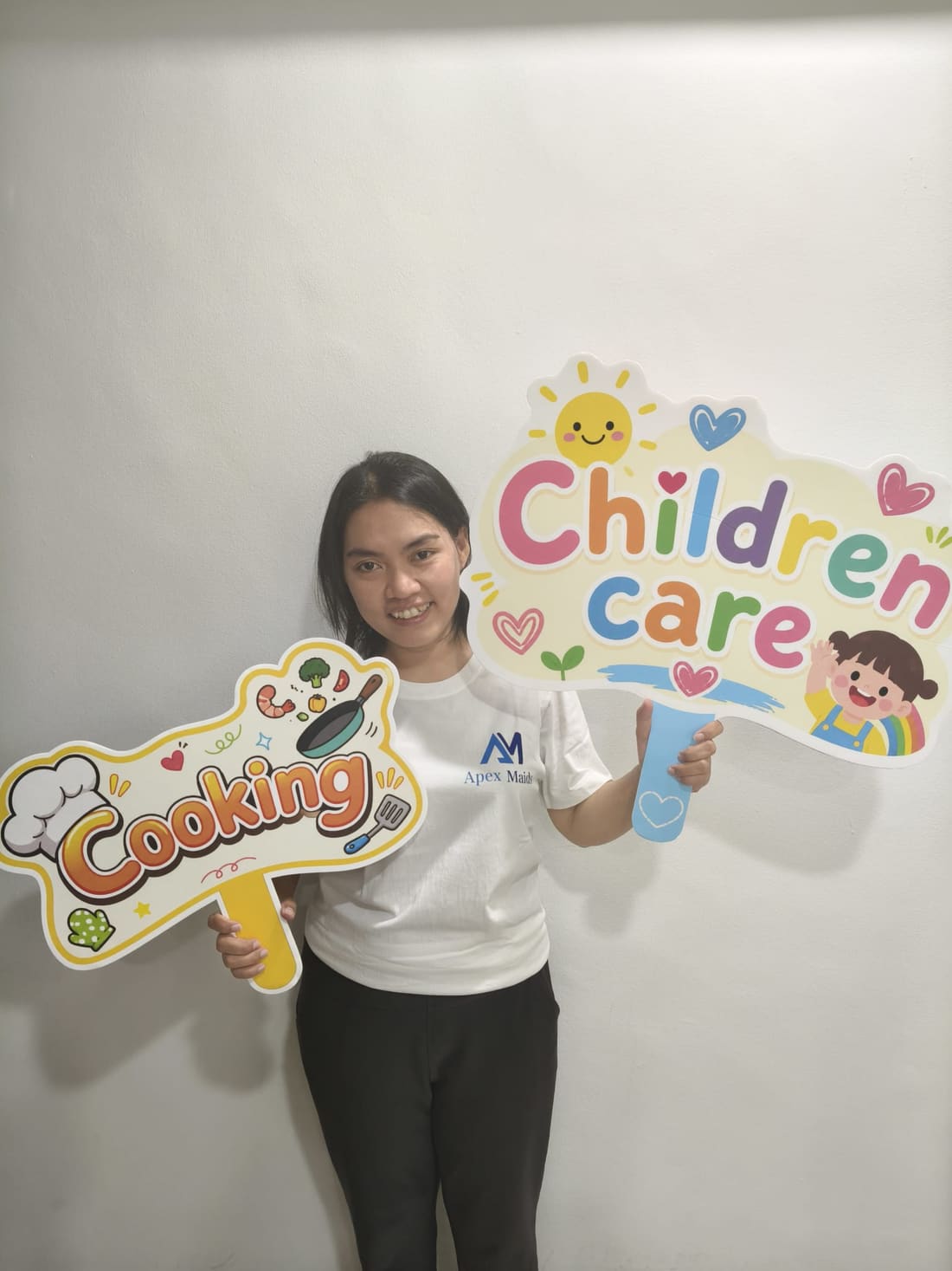 Apex Maids helper holding cooking and housekeeping placards